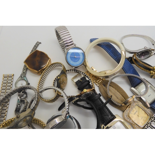 738 - A large collection of fashion watches to include Swatch