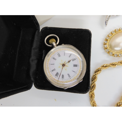 753 - A continental silver fob watch with a decorative dial and a collection of costume jewellery