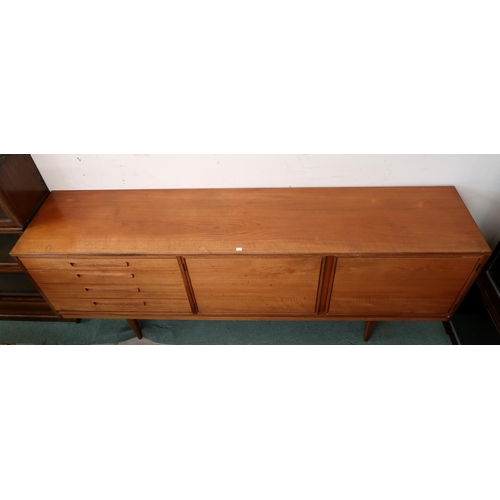 87 - A mid 20th century teak Alfred Cox sideboard on shaped tapering supports, 76cm high x 207cm wide x 4... 