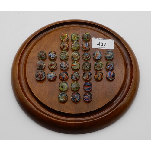 487 - A solitaire game board with a complete set of marbles