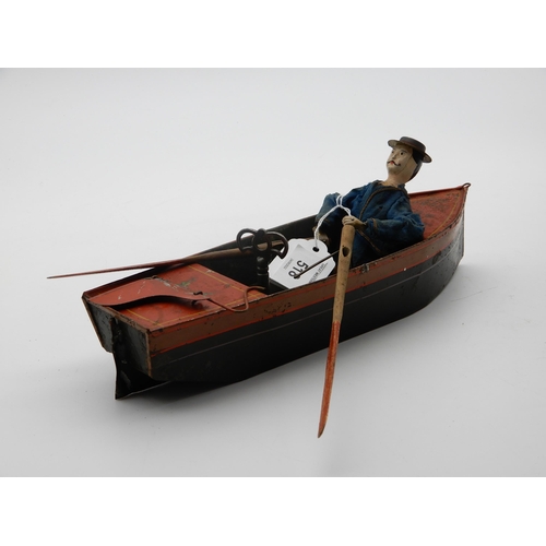 518 - A tin clockwork rowboat and oarsman by E.R. Ives circa 1869