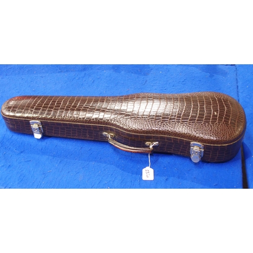 557A - A violin case in faux crocodile skin