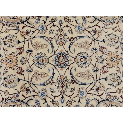 137 - A CREAM GROUND FINE KASHAN RUGwith all over floral foliate design and flowerhead border, 367cm long ... 