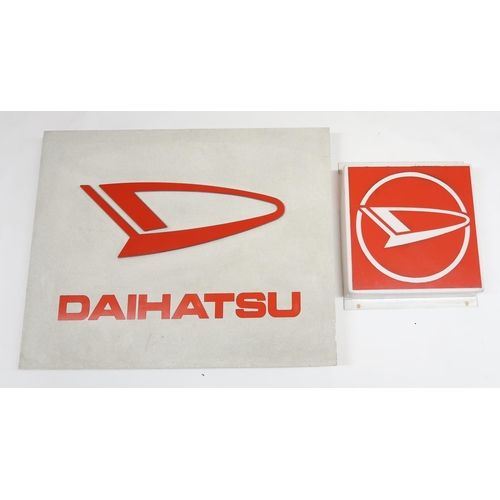 530 - AUTOMOBILIAA Daihatsu car showroom backlit advertising sign and a Daihatsu logo lightbox adverting s... 