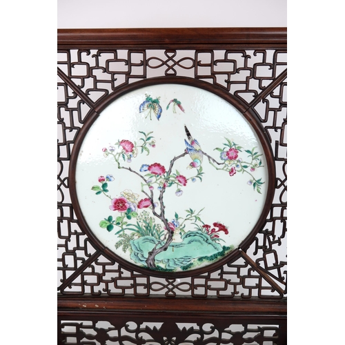 310A - A CHINESE FAMILLE ROSE TILE TABLE SCREENpainted with a bird amongst flowering branches and above roc... 