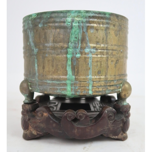 313A - A CHINESE ARCHAIC STYLE BRASS CENSER cast with horizontal bands, seal mark and on three feet, w... 