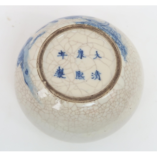 315A - A CHINESE BLUE AND WHITE CRACKLEWARE BOWLpainted with a figure confronting a snake, six character ma... 