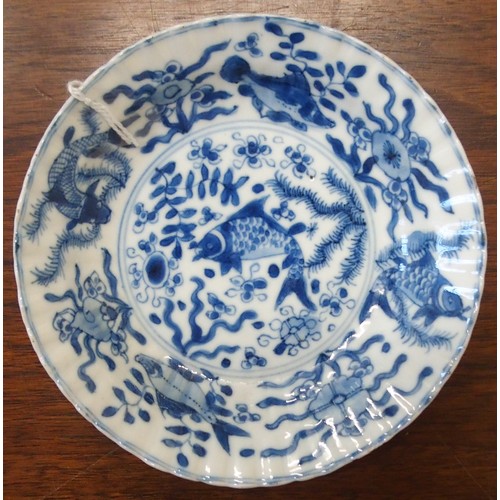 323 - A CHINESE BLUE AND WHITE DISHpainted with precious objects, within a foliate band, 27.5cm diameter, ... 