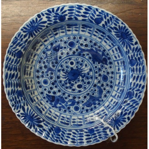 323 - A CHINESE BLUE AND WHITE DISHpainted with precious objects, within a foliate band, 27.5cm diameter, ... 