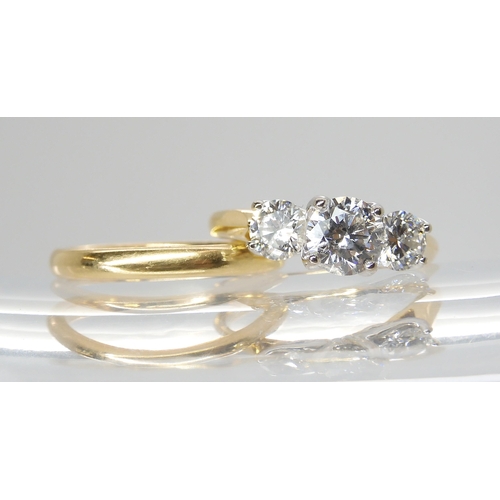 723 - An 18ct gold three stone diamond ring set with estimated approx 1.20cts in total, in a pretty leaf d... 