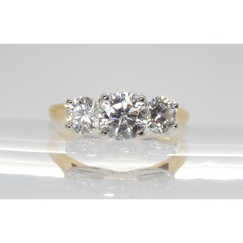 723 - An 18ct gold three stone diamond ring set with estimated approx 1.20cts in total, in a pretty leaf d... 