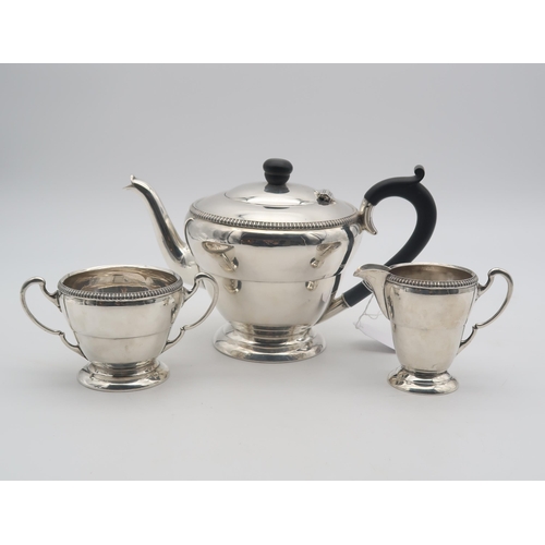 441 - A George VI silver bachelors tea service, of flared form, the body with banding, with gadrooned rims... 