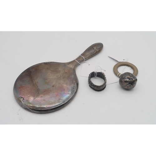 447 - A silver baby rattle modelled as a peach, by Crisford & Norris Ltd, Birmingham 1934, a silver ci... 