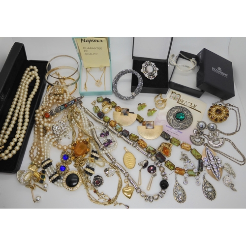 902 - A Swarovski bracelet, a pendant and earring set by Napier, a carded Miracle brooch and other items