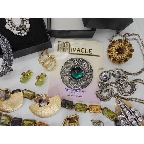 902 - A Swarovski bracelet, a pendant and earring set by Napier, a carded Miracle brooch and other items