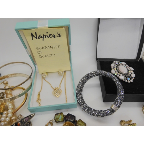 902 - A Swarovski bracelet, a pendant and earring set by Napier, a carded Miracle brooch and other items