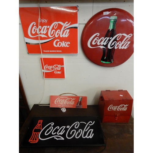 114 - A mixed lot of assorted Coca Cola items to include two illuminated advertising signs, three further ... 