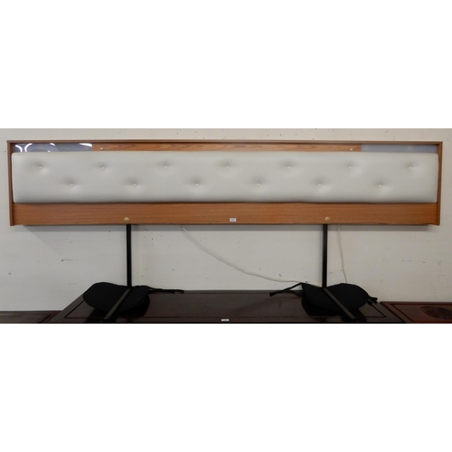 117 - A mid 20th century teak and white vinyl button back headboard