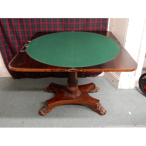 12 - A Victorian rosewood fold over games table on quadrupedal base with paw feet