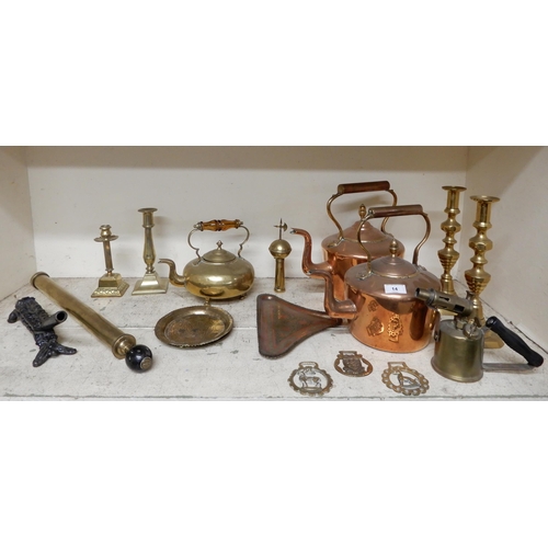14 - A mixed lot of copper and brass to include kettles, candlesticks etc