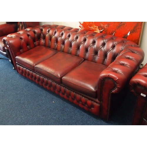 146 - A 20th century button back Chesterfield style club settee upholstered in red leather