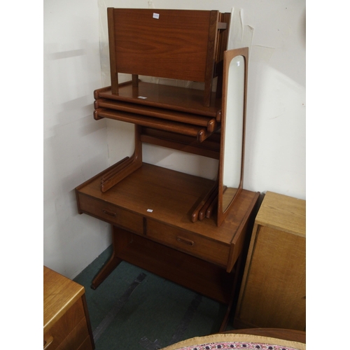 166 - A mid 20th century teak two drawer telephone table, nest of three tables, magazine rack and wall mir... 