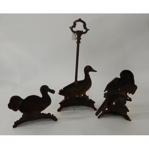17 - A lot of three cast iron door stops in the form of birds and a carved wood wall panel (4)