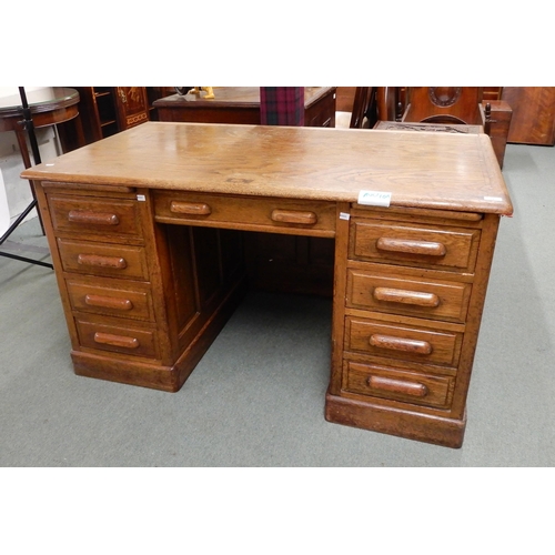 27 - An early 20th oak twin pedestal desk