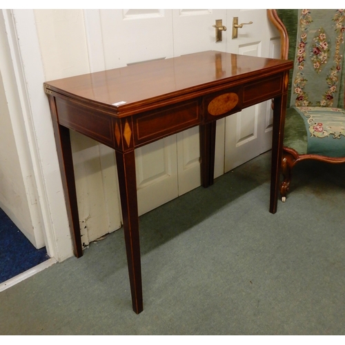 34 - A Victorian mahogany and satinwood inlaid fold over tea table