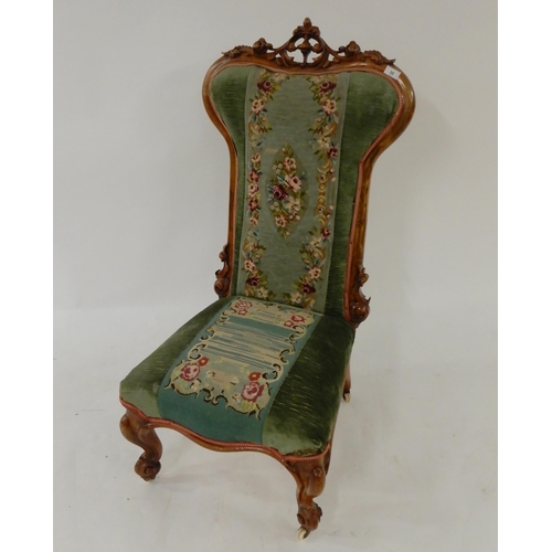 35 - A Victorian walnut framed Prie Dieu chair with floral tapestry upholstery on cabriole supports