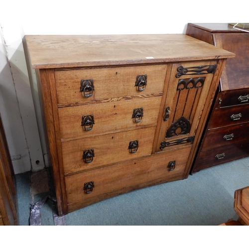 43 - An early 20th century oak Arts and Crafts chest of drawers with three short drawers beside single ca... 