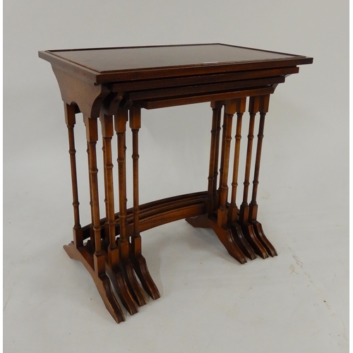 54 - A 20th century Bradley mahogany nest of four tables with turned uprights on out swept feet