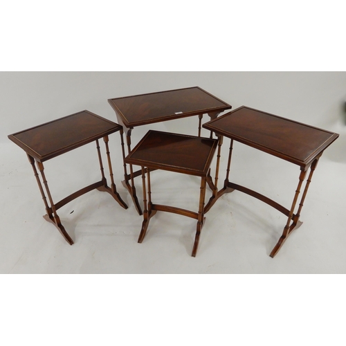 54 - A 20th century Bradley mahogany nest of four tables with turned uprights on out swept feet