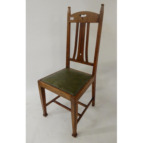 55 - A set of four early 20th century oak arts and crafts style dining chairs (4)