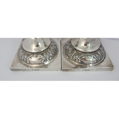 186 - A pair of silver candlesticks