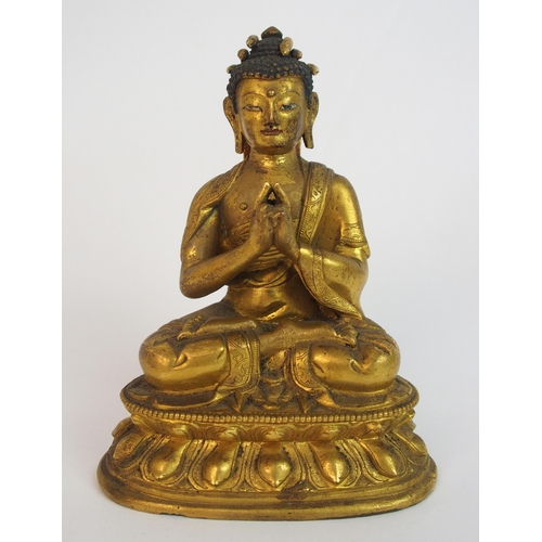 62 - A Sino-Tibetan gilt bronze model of Buddha