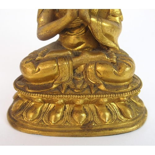 62 - A Sino-Tibetan gilt bronze model of Buddha