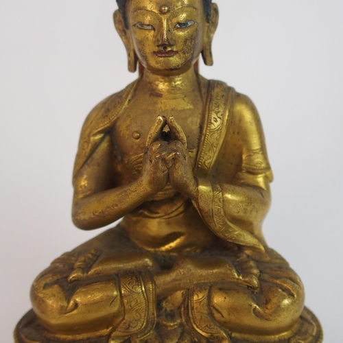 62 - A Sino-Tibetan gilt bronze model of Buddha