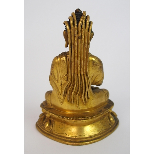 62 - A Sino-Tibetan gilt bronze model of Buddha