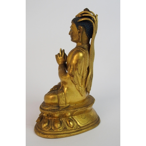 62 - A Sino-Tibetan gilt bronze model of Buddha