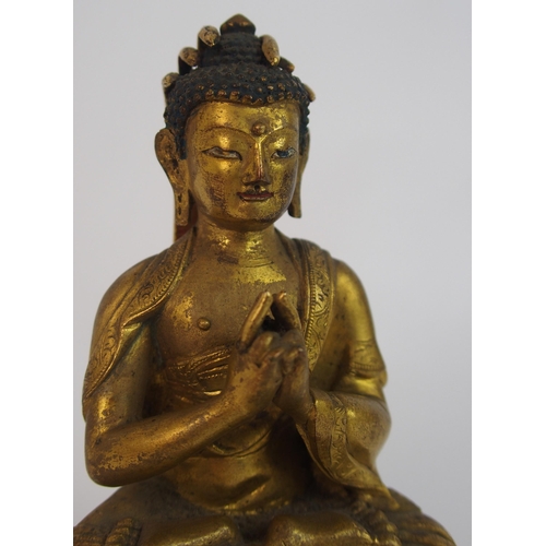 62 - A Sino-Tibetan gilt bronze model of Buddha