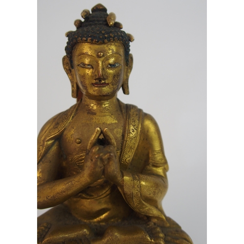 62 - A Sino-Tibetan gilt bronze model of Buddha