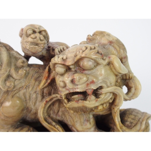 70 - A Chinese alabaster carved model of a buddhistic lion and cubs