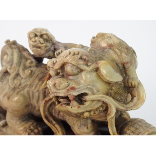 70 - A Chinese alabaster carved model of a buddhistic lion and cubs