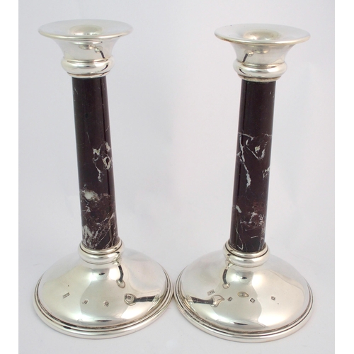 155 - A pair of silver candlesticks