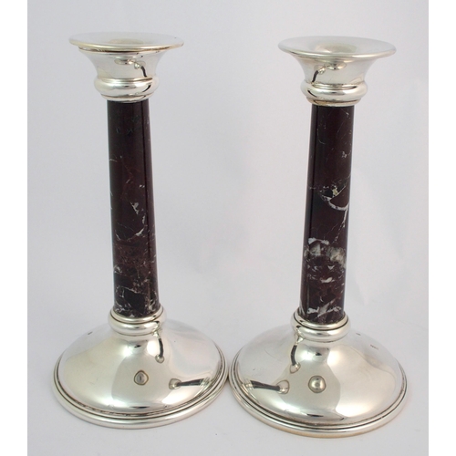 155 - A pair of silver candlesticks