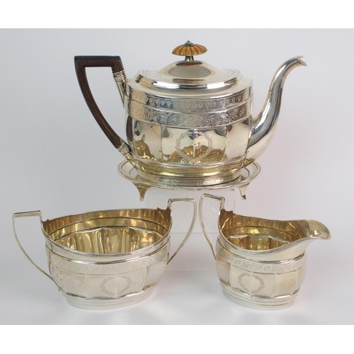 162 - A three piece silver tea service with teapot stand