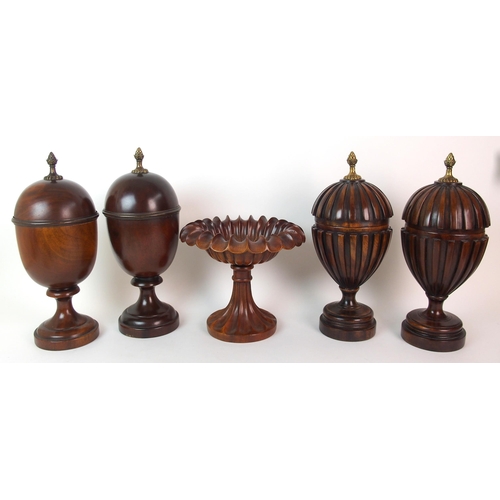 404 - A pair of fluted mahogany urns and covers