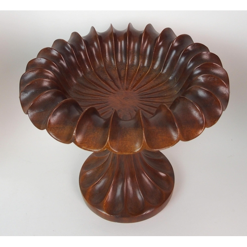 404 - A pair of fluted mahogany urns and covers