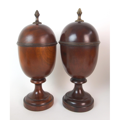 404 - A pair of fluted mahogany urns and covers